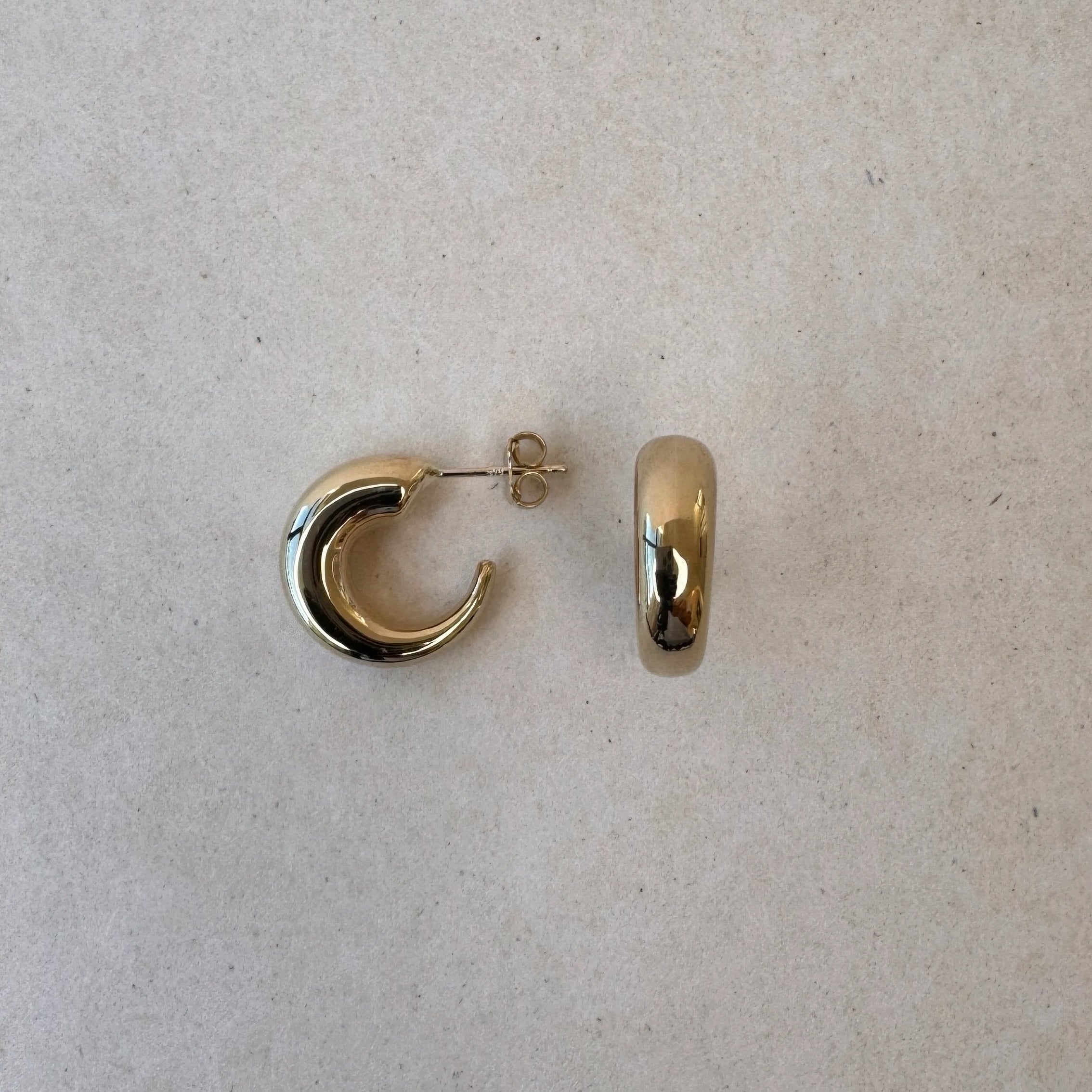 Eyre Hoop earring showcasing the slim silhouette and soft gold tone