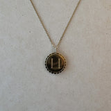 Reversible 9ct gold ‘H’ pendant with scalloped edge and diamond rotating bail, engraved on one side and polished on the reverse.