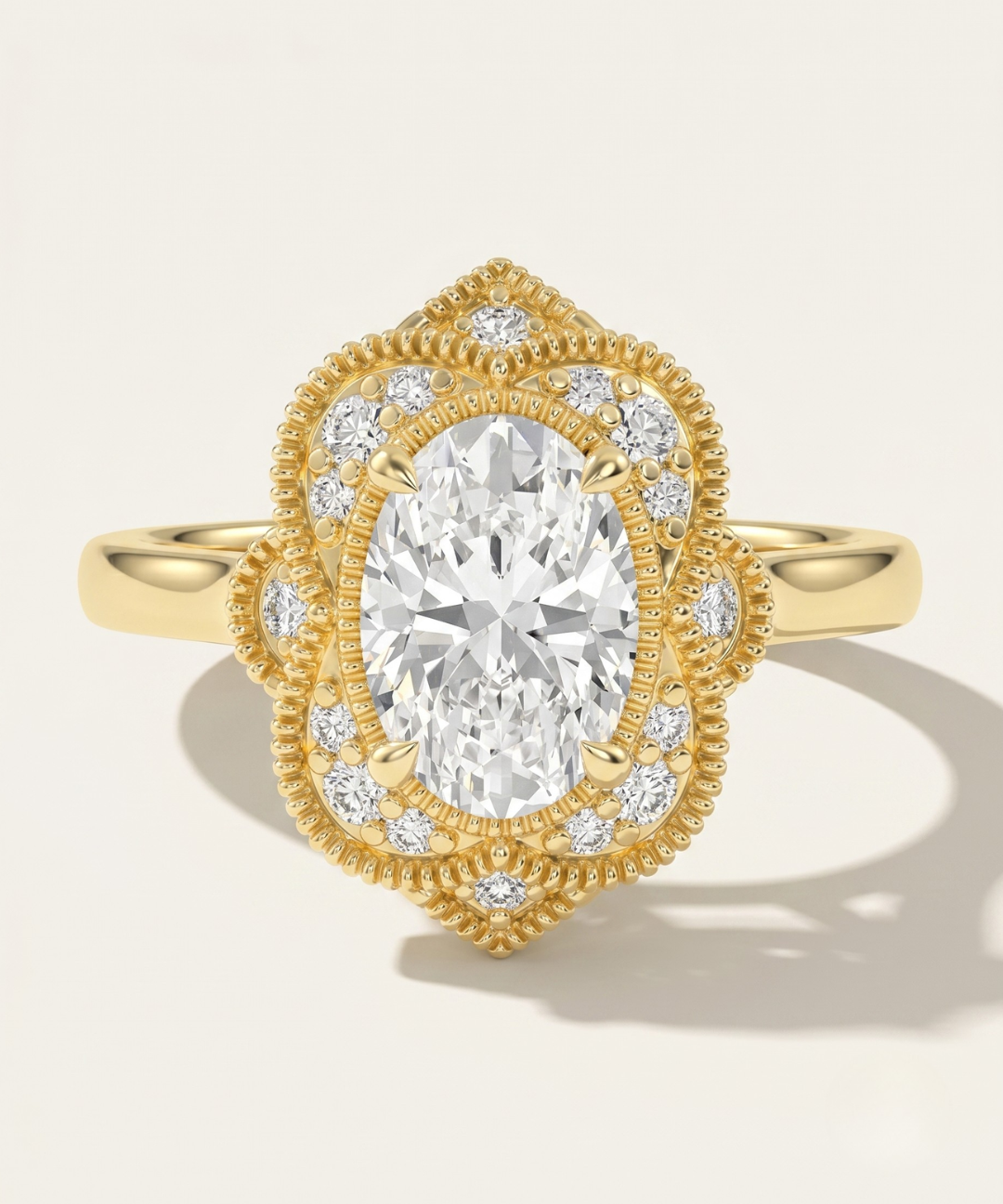MOHSTEN The Capri vintage scalloped milgrain halo oval engagement ring in 18ct yellow gold.