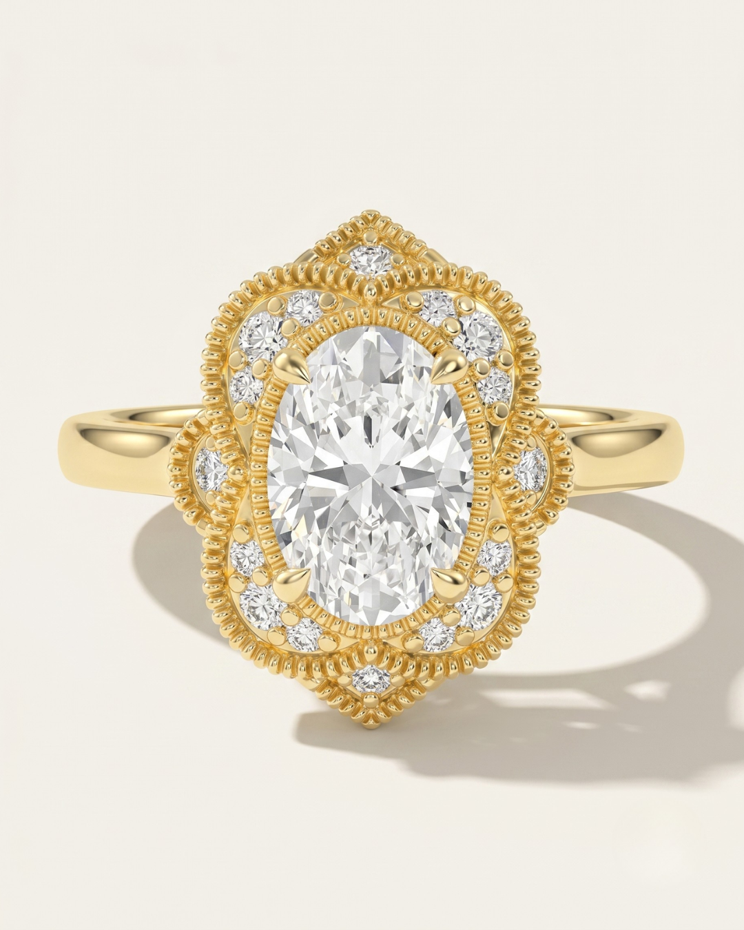 MOHSTEN The Capri vintage scalloped milgrain halo oval engagement ring in 18ct yellow gold.