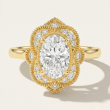 MOHSTEN The Capri vintage scalloped milgrain halo oval engagement ring in 18ct yellow gold.