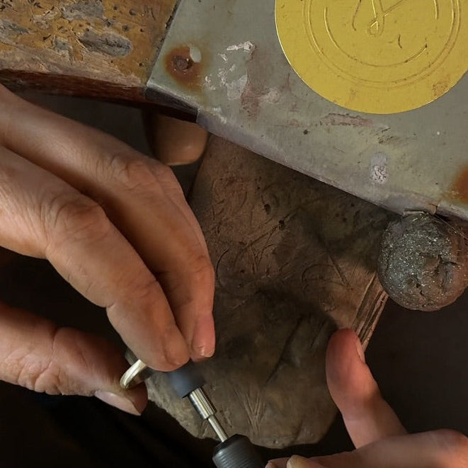 Close-up of hands working with a jewellery tool in workshop. MOHSTEN jewellery workshop