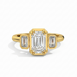 Gold ring with emerald-cut diamond and baguette diamonds on a white background