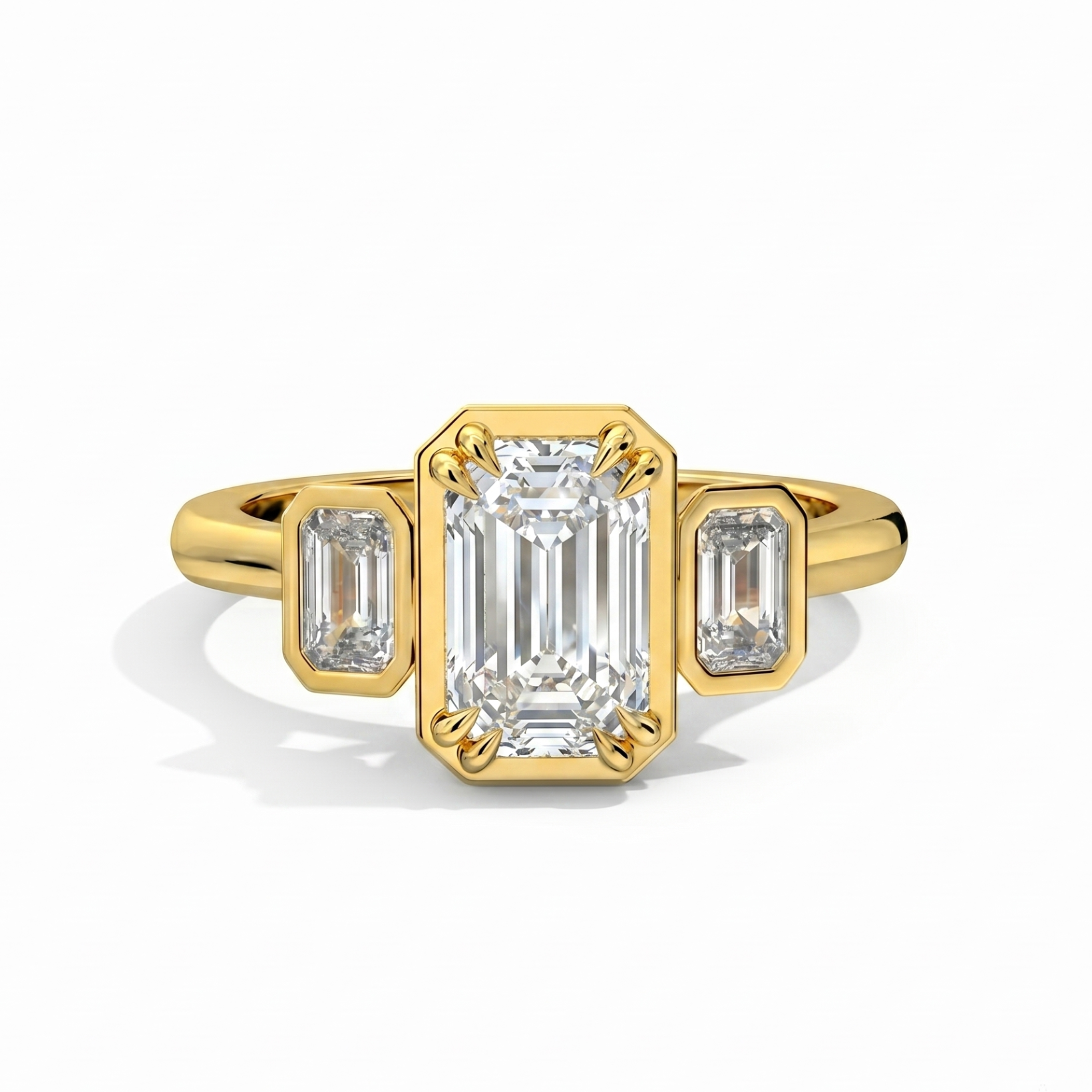 Gold ring with emerald-cut diamond and baguette diamonds on a white background