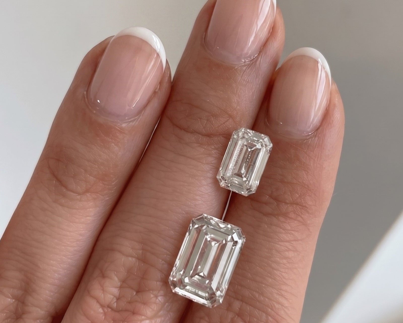 Diamond on a hand with a neutral background