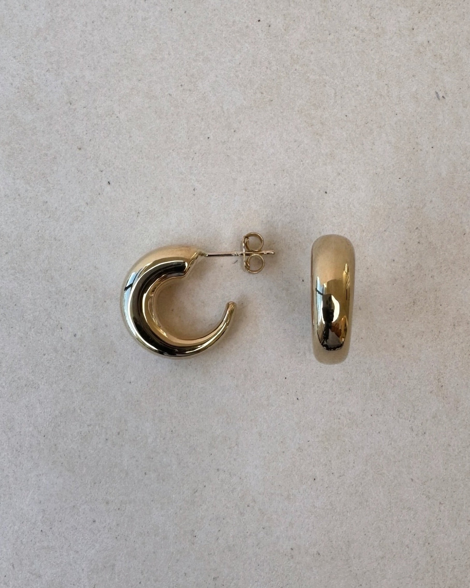 Eyre Hoop earring showcasing the slim silhouette and soft gold tone
