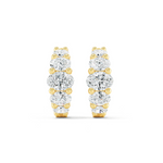 A pair of oval huggie earrings featuring multiple diamond cuts, set in either white or yellow gold.