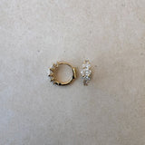 Lucerne Oval Huggies in 18ct gold shown side by side, highlighting symmetry and oval diamond layout