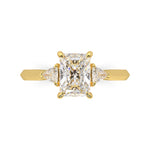 MOHSTEN JEWELLERS - Monaco -  radiant cut diamond cathedral trilogy trillion side stone engagement ring, yellow gold, top view 