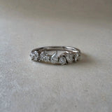 Diamond ring with a white gold band on a light grey background
