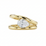Gold ring with a pear-shaped diamond on a white background