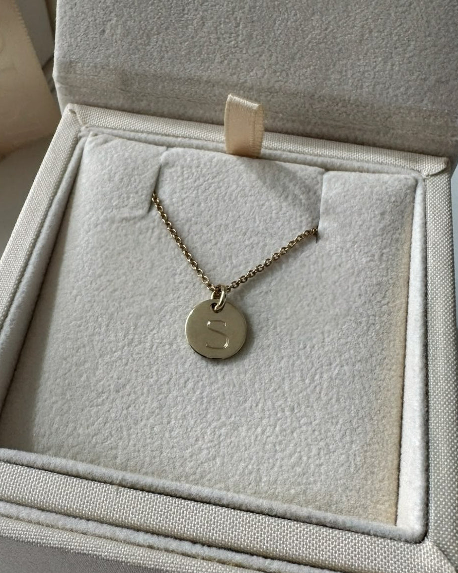 Gold necklace with a pendant in a Mohsten jewelry box