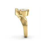Gold ring with a diamond on a white background