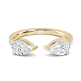 A gold band with two pear cut lab grown diamonds and round brilliant cuts set down the band.