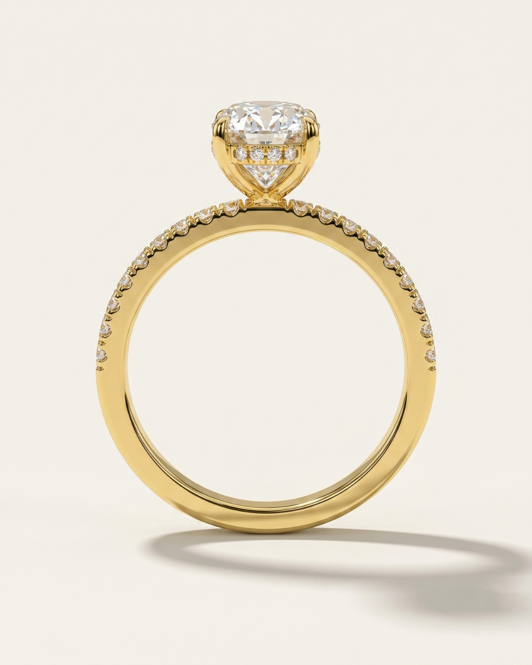 Side profile architecture view of the MOHSTEN Aspen oval diamond engagement ring in 18ct yellow gold highlighting the hidden halo design and accent diamond band.