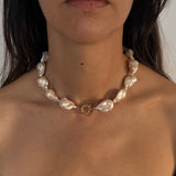 Woman wearing the MOHSTEN Baroque Pearl Necklace, featuring massive 13mm freshwater pearls and a front-facing 9ct yellow gold bolt ring clasp.