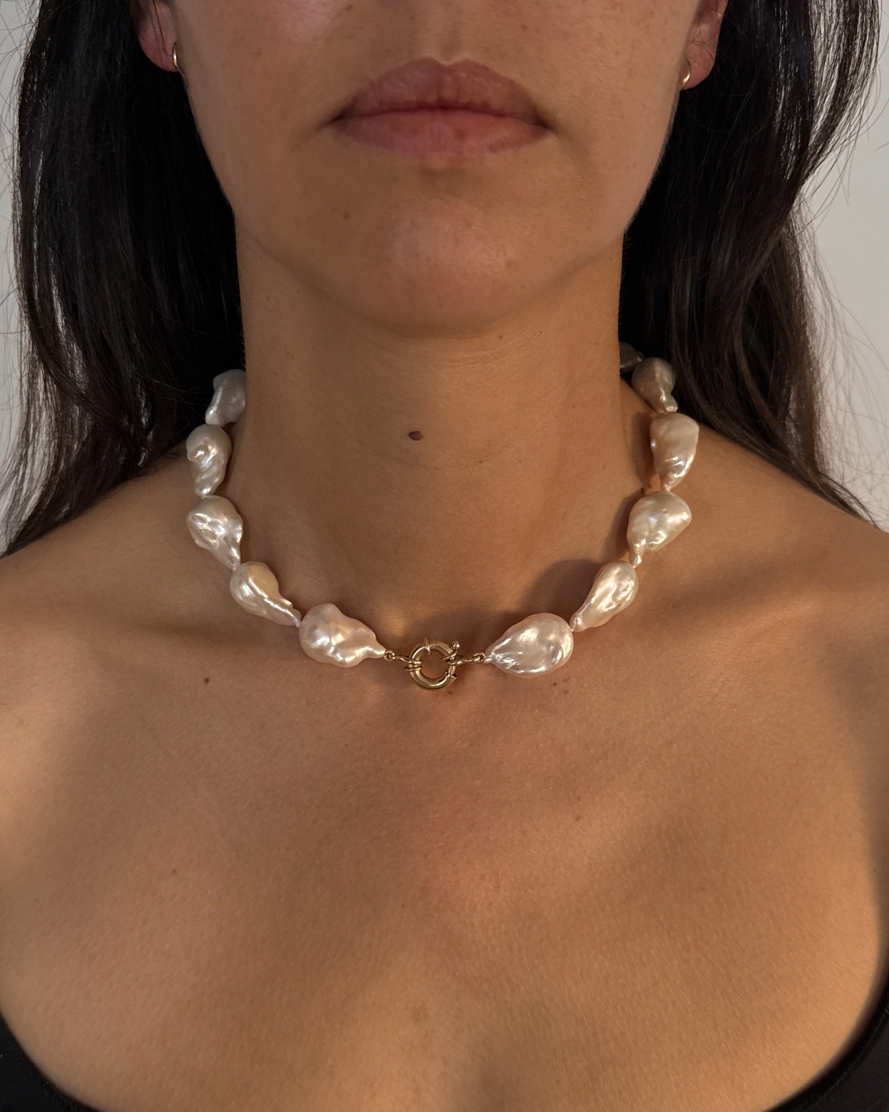Woman wearing the MOHSTEN Baroque Pearl Necklace, featuring massive 13mm freshwater pearls and a front-facing 9ct yellow gold bolt ring clasp.
