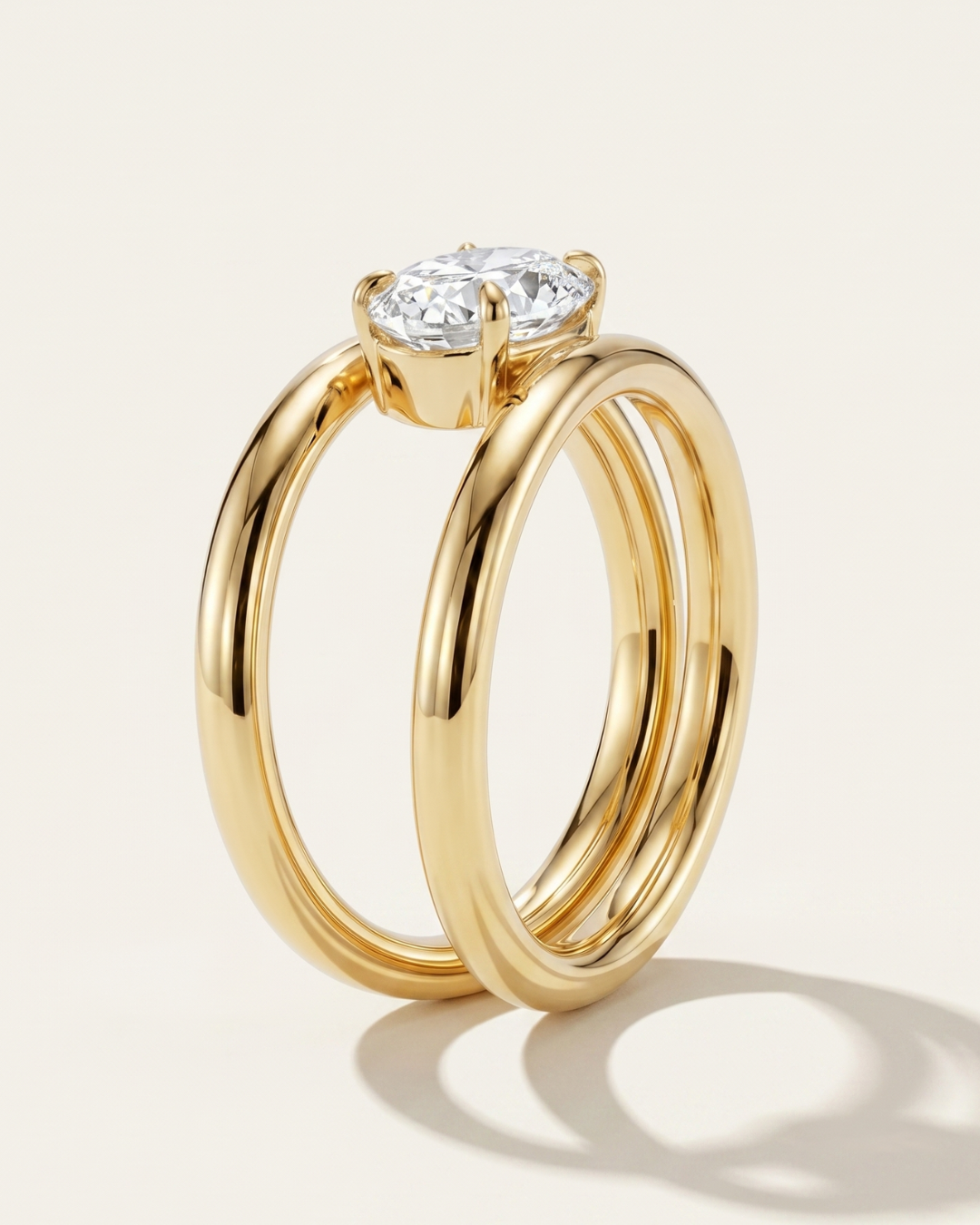 Side profile view of the MOHSTEN Beaufort pear diamond double band engagement ring in 18ct yellow gold showcasing the parallel split-shank architecture and the East-West stone setting.