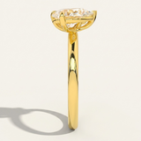 Side profile view of the MOHSTEN Cairo pear diamond Toi et Moi engagement ring in 18ct yellow gold, showcasing the low-profile setting architecture and elegant shadow on a minimalist studio background.