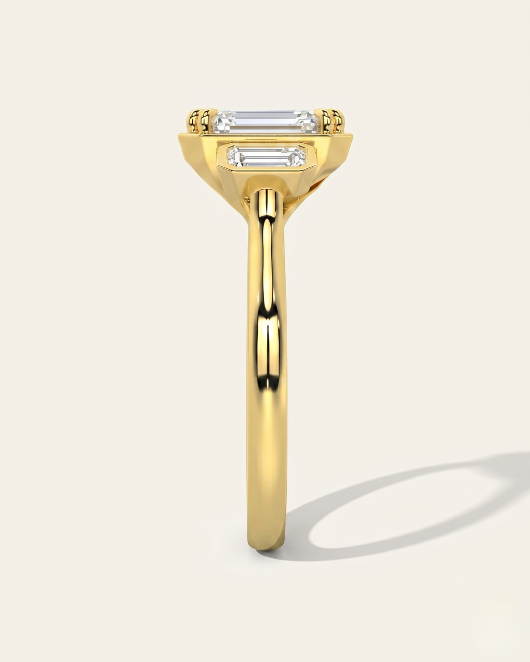 End profile view of the MOHSTEN Duval trilogy engagement ring in 18ct yellow gold, highlighting the architectural octagonal double-claw basket design and low-profile setting.