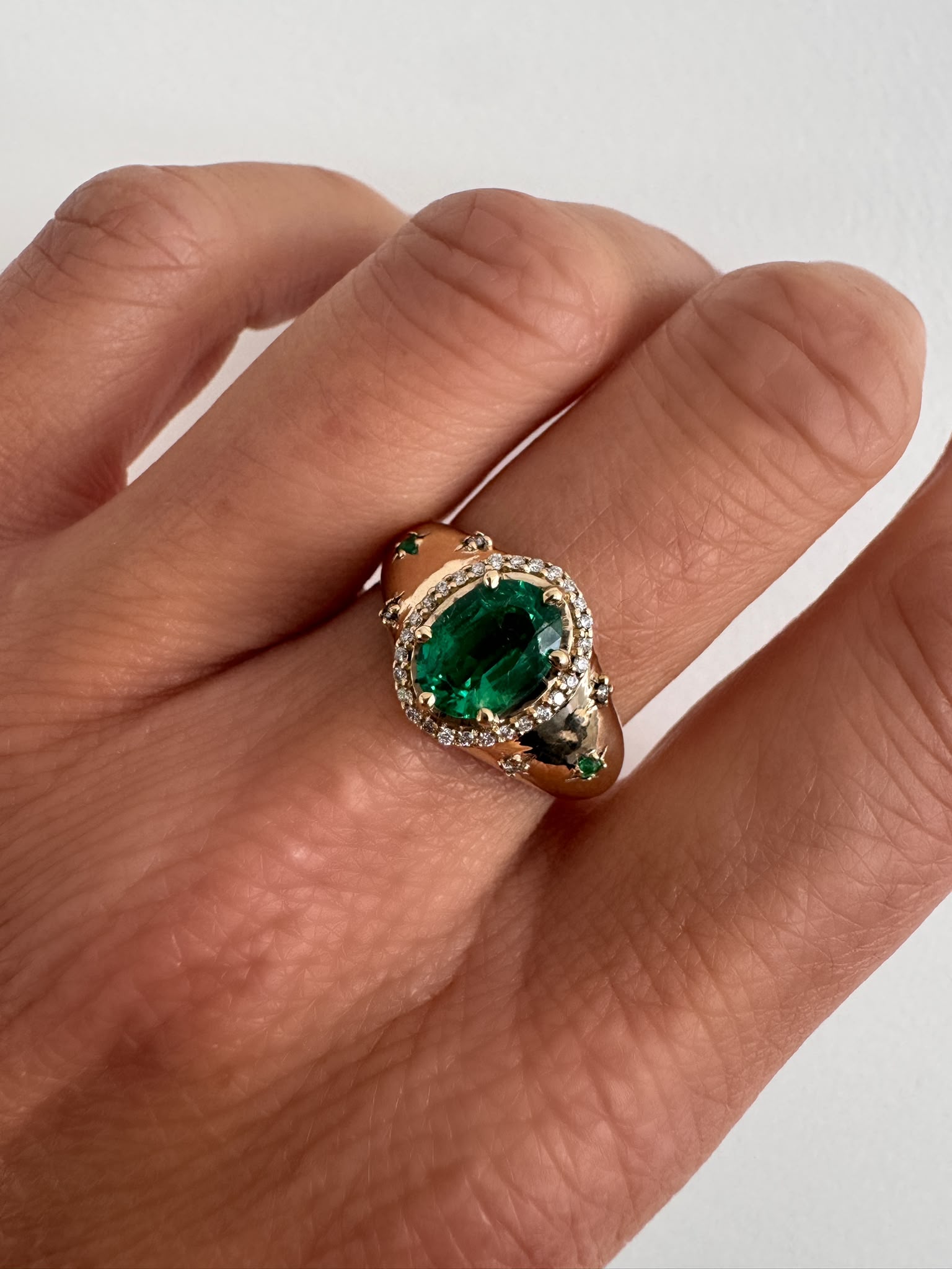Green oval emerald ring on hand by MOHSTEN