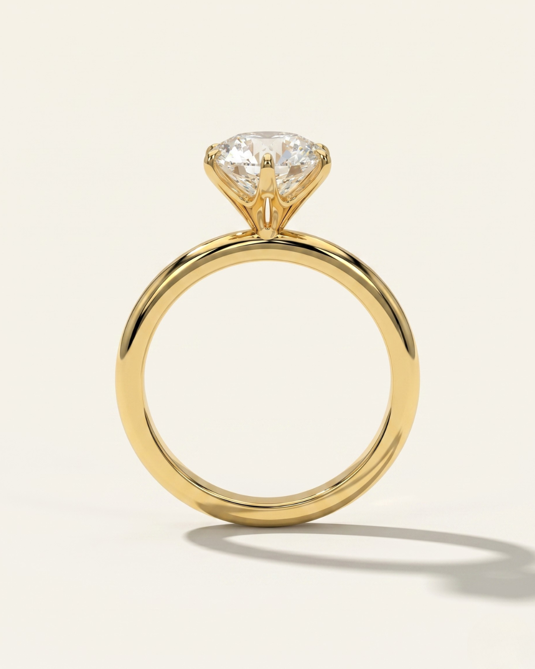 Side profile through-finger view of the MOHSTEN Jaipur round diamond solitaire engagement ring in 18ct yellow gold highlighting the minimalist signature 6-prong setting architecture.