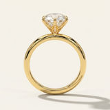 Side profile through-finger view of the MOHSTEN Jaipur round diamond solitaire engagement ring in 18ct yellow gold highlighting the minimalist signature 6-prong setting architecture.