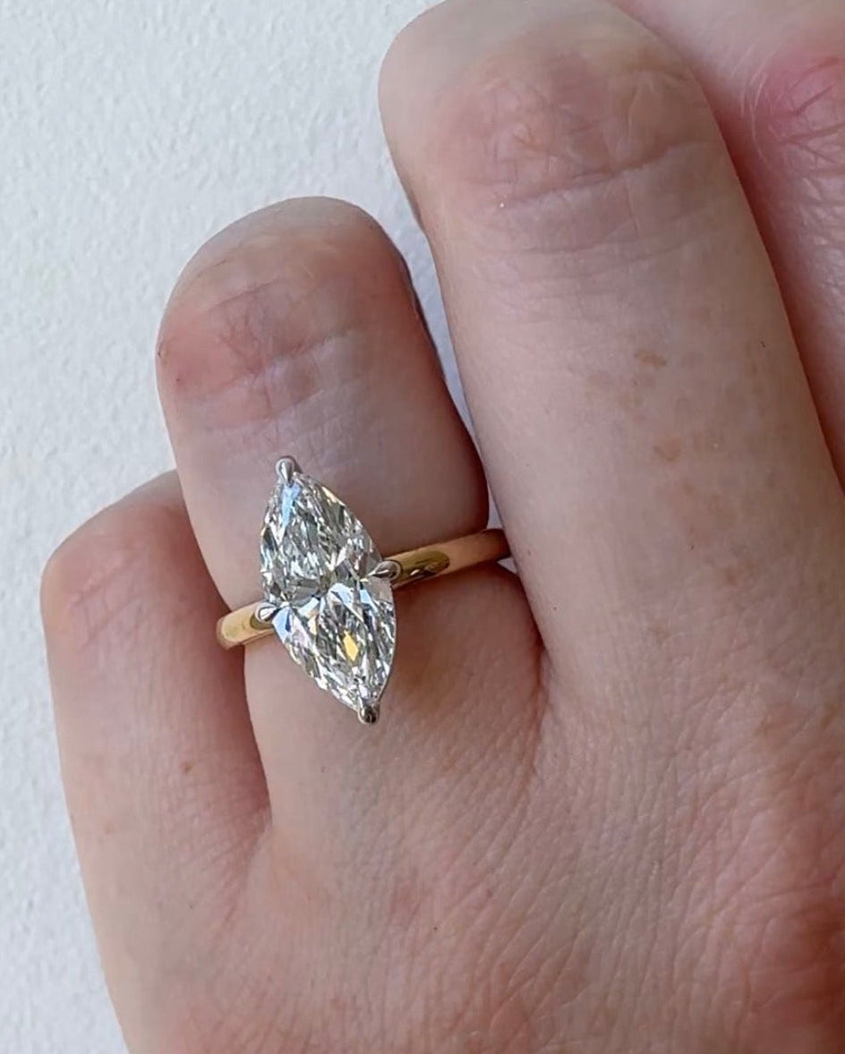 MOHSTEN Niseko marquise diamond solitaire engagement ring modelled on hand, displaying its elongated architectural silhouette and high-polish 1.8mm band.