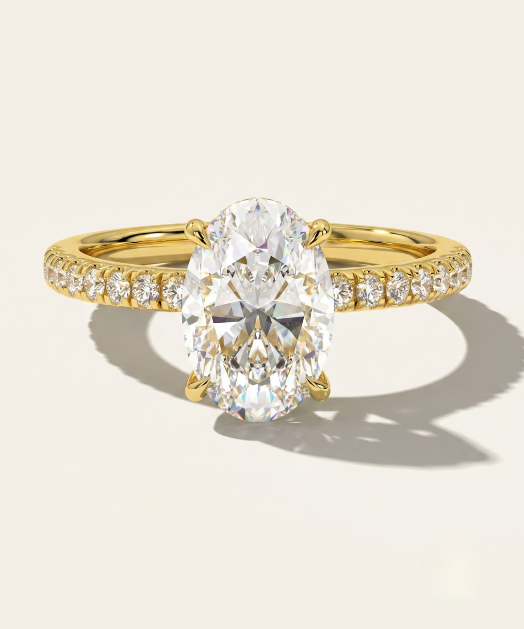 MOHSTEN Aspen oval diamond solitaire engagement ring in 18ct yellow gold showcasing an elongated oval brilliant centre stone and a fluid scalloped diamond-set band.