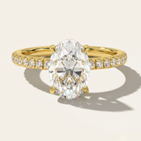 MOHSTEN Aspen oval diamond solitaire engagement ring in 18ct yellow gold showcasing an elongated oval brilliant centre stone and a fluid scalloped diamond-set band.