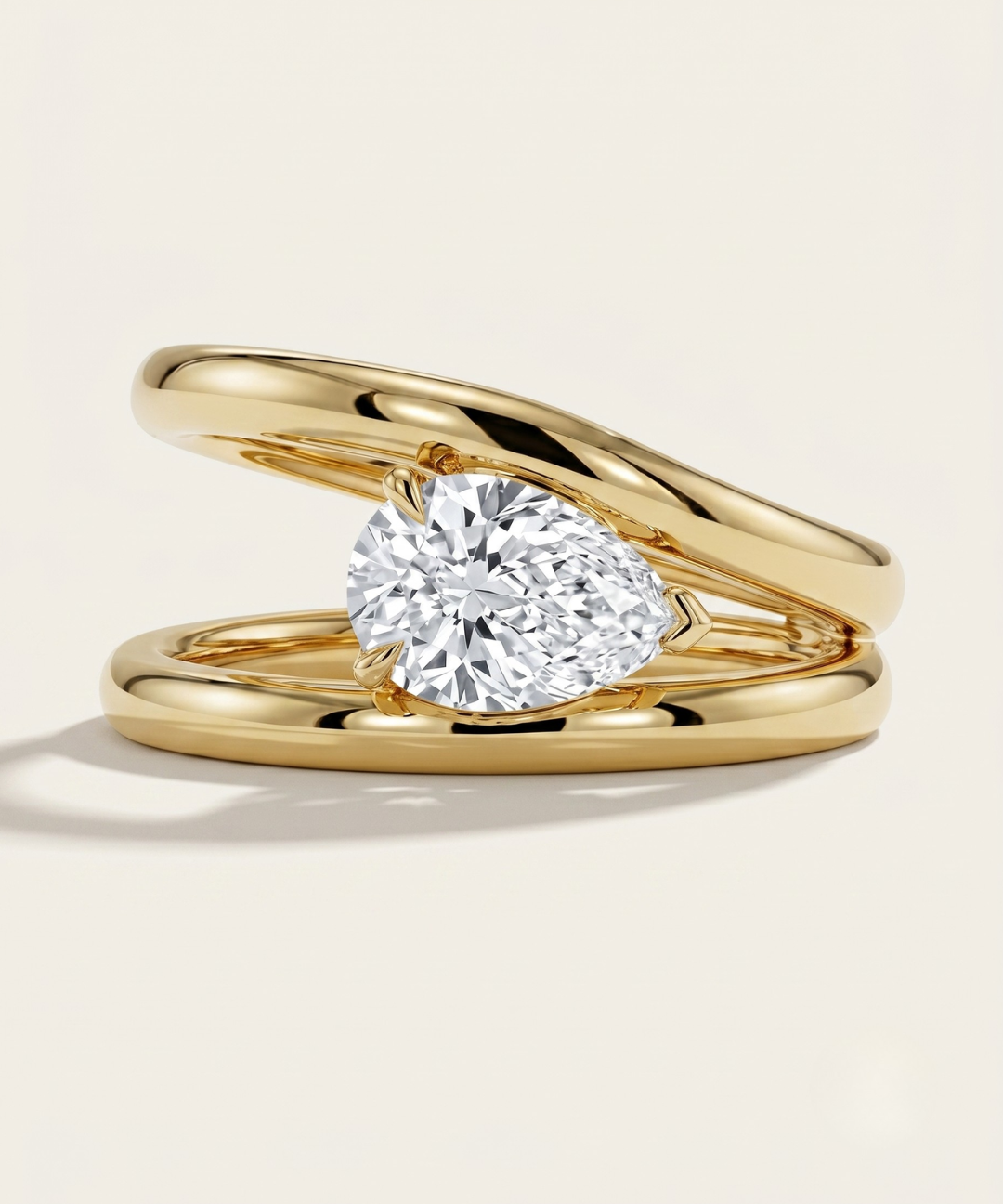 MOHSTEN Beaufort pear diamond double band engagement ring in 18ct yellow gold showcasing an east-west oriented pear diamond floating within an architectural split band.