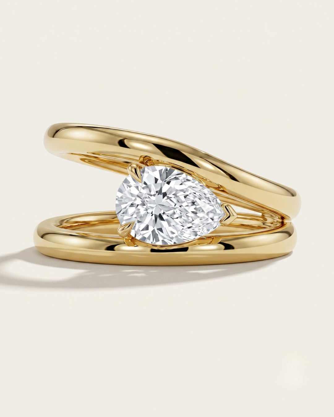 MOHSTEN Beaufort pear diamond double band engagement ring in 18ct yellow gold showcasing an east-west oriented pear diamond floating within an architectural split band.