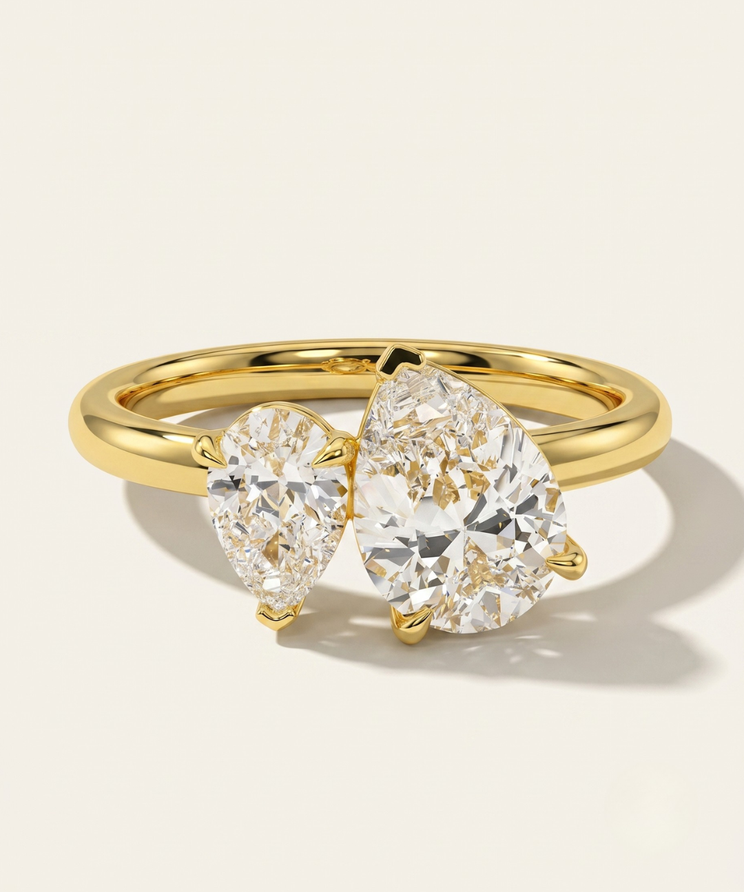 MOHSTEN Cairo pear diamond Toi et Moi engagement ring in 18ct yellow gold showcasing two asymmetrical pear-cut diamonds set side-by-side on a refined high-polish band.