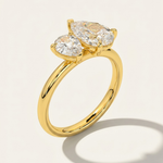MOHSTEN Cairo pear diamond Toi et Moi engagement ring in 18ct yellow gold showcasing a three-quarter perspective view of the two asymmetrical pear-cut diamonds casting a prominent architectural shadow on a light studio background.