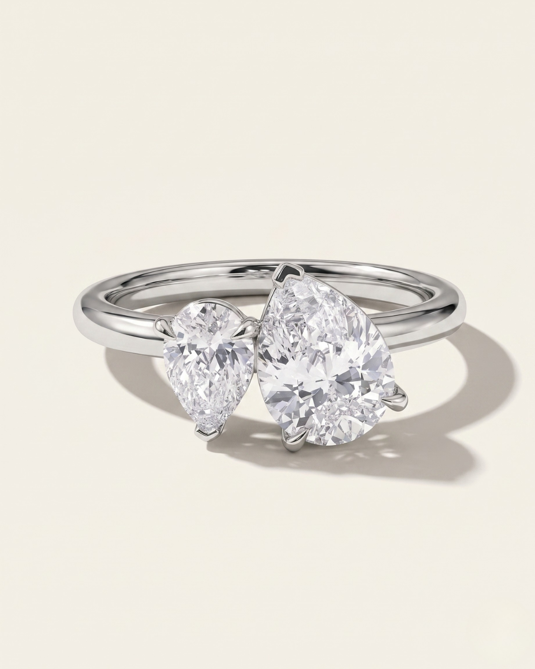 MOHSTEN Cairo pear diamond Toi et Moi engagement ring in polished platinum showcasing two asymmetrical pear-cut diamonds set side-by-side on a refined band.