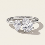 MOHSTEN Cairo pear diamond Toi et Moi engagement ring in polished platinum showcasing two asymmetrical pear-cut diamonds set side-by-side on a refined band.