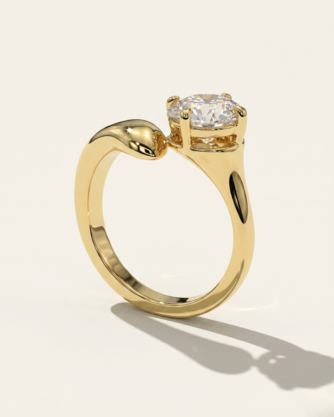 Side profile view of the MOHSTEN Granada asymmetric round diamond solitaire engagement ring in 18ct yellow gold, showcasing the unique low-profile basket setting and sweeping band architecture casting a distinct shadow on a warm studio background.
