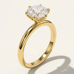 An angled three-quarter studio view of the MOHSTEN Jaipur round diamond solitaire engagement ring in 18ct yellow gold, highlighting the high-polish comfort-fit band and the structural 6-prong setting architecture.