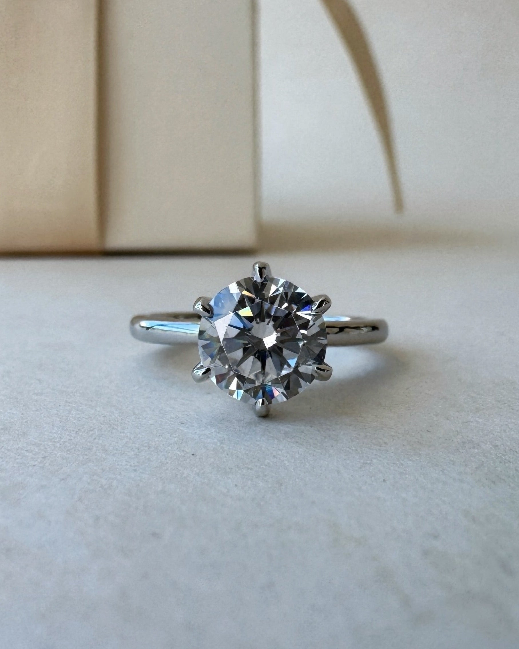 MOHSTEN Jaipur round diamond solitaire engagement ring in polished platinum showcasing a premium round brilliant centre stone in a minimalist signature 6-prong setting.