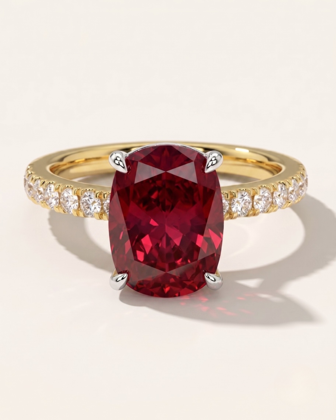 MOHSTEN Manila elongated cushion-cut ruby engagement ring in 18ct yellow gold featuring a solitaire red ruby in a 4-claw floating basket setting on a brilliant diamond-set band.