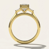 MOHSTEN Montreux 18ct yellow gold three-stone engagement ring standing front view with emerald cut diamond.