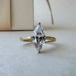 MOHSTEN Niseko diamond engagement ring in 18ct yellow gold featuring a solitaire marquise cut centre stone with protective prongs. ring with packaging
