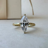MOHSTEN Niseko diamond engagement ring in 18ct yellow gold featuring a solitaire marquise cut centre stone with protective prongs. ring with packaging
