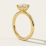 MOHSTEN Osaka oval diamond solitaire engagement ring in 18ct yellow gold from a direct side profile standing view, highlighting the architectural 4-prong basket setting and its elegant shadow on a minimalist studio background.