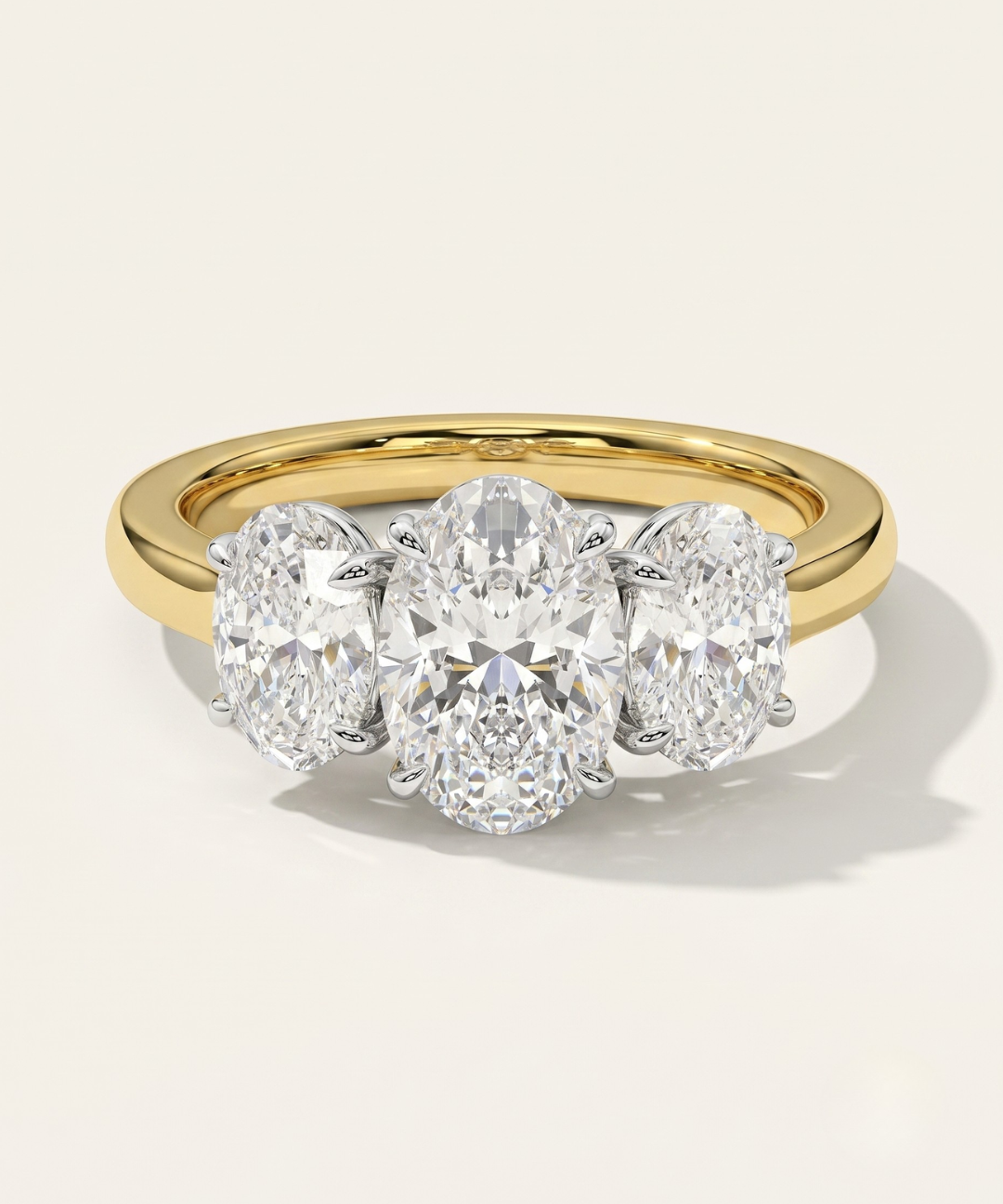 MOHSTEN Sydney oval diamond trilogy engagement ring in 18ct yellow gold showcasing a premium central oval diamond flanked symmetrically by two matching oval side stones.