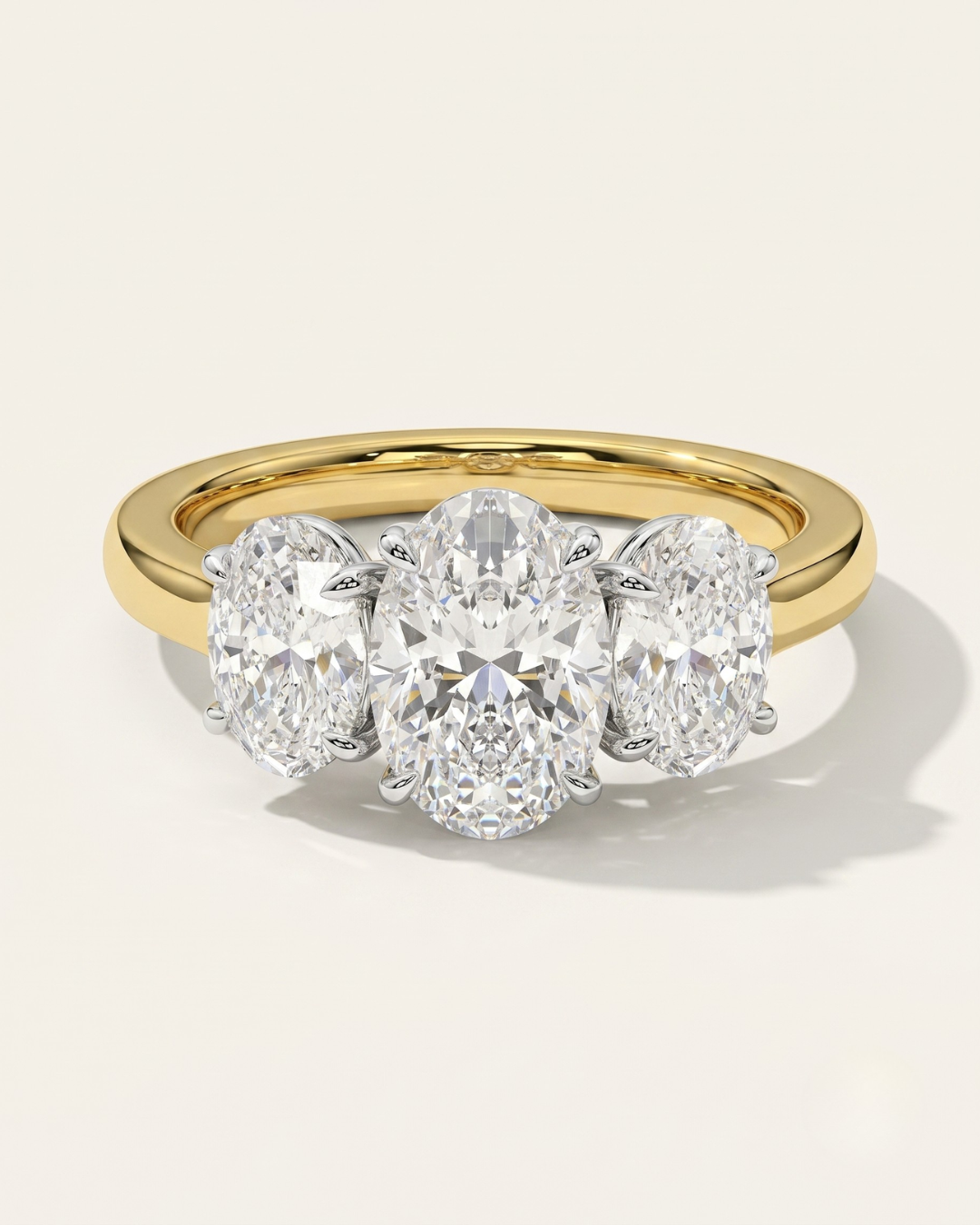 MOHSTEN Sydney oval diamond trilogy engagement ring in 18ct yellow gold showcasing a premium central oval diamond flanked symmetrically by two matching oval side stones.