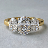 MOHSTEN Sydney oval diamond trilogy engagement ring in 18ct yellow gold showcasing a premium central oval diamond flanked symmetrically by two matching oval side stones.