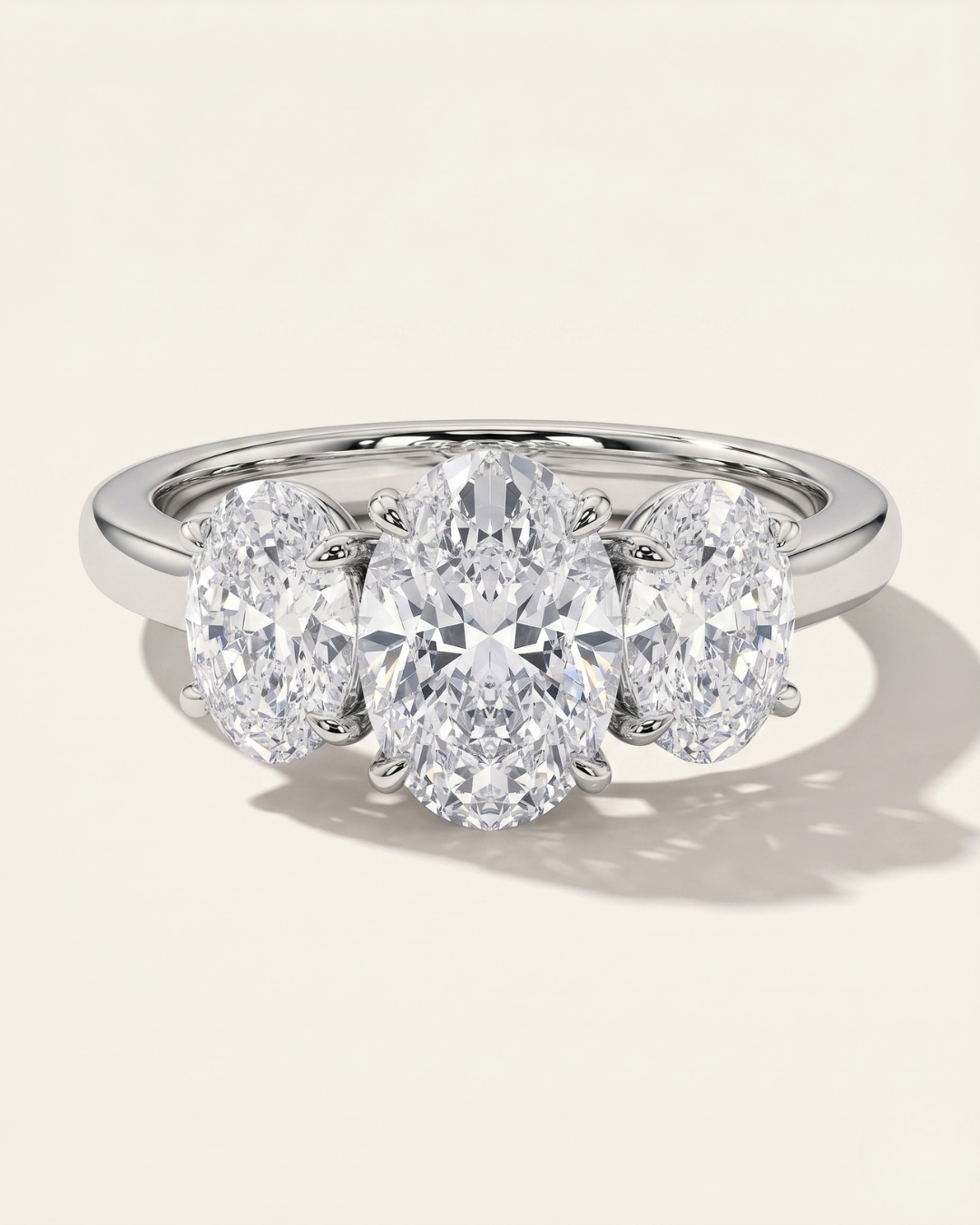 MOHSTEN Sydney oval diamond trilogy engagement ring in polished platinum showcasing three beautifully matched oval-cut diamonds on a sleek cathedral band.