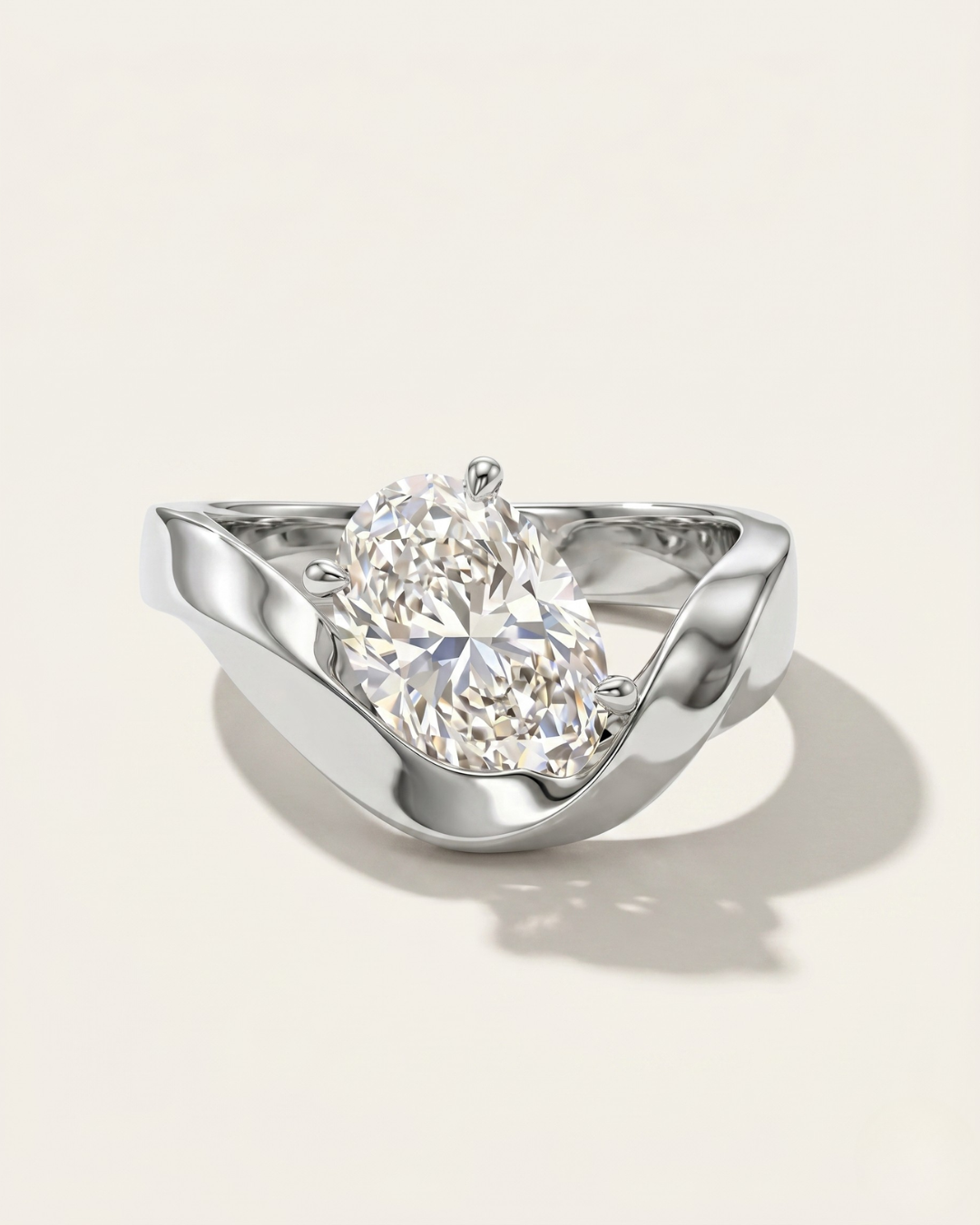 MOHSTEN Tairua oval diamond solitaire engagement ring in polished platinum showcasing an asymmetric, organically angled oval centre diamond nestled in a fluid bypass ribbon band.