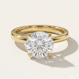 MOHSTEN Uluwatu round diamond solitaire engagement ring in 18ct yellow gold showcasing a premium round brilliant centre stone in a minimalist 4-prong basket setting.